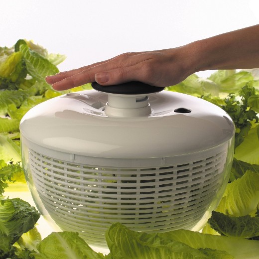 628331_Alt14 Hand on top of an OXO salad spinner. Lettuce is in the background.