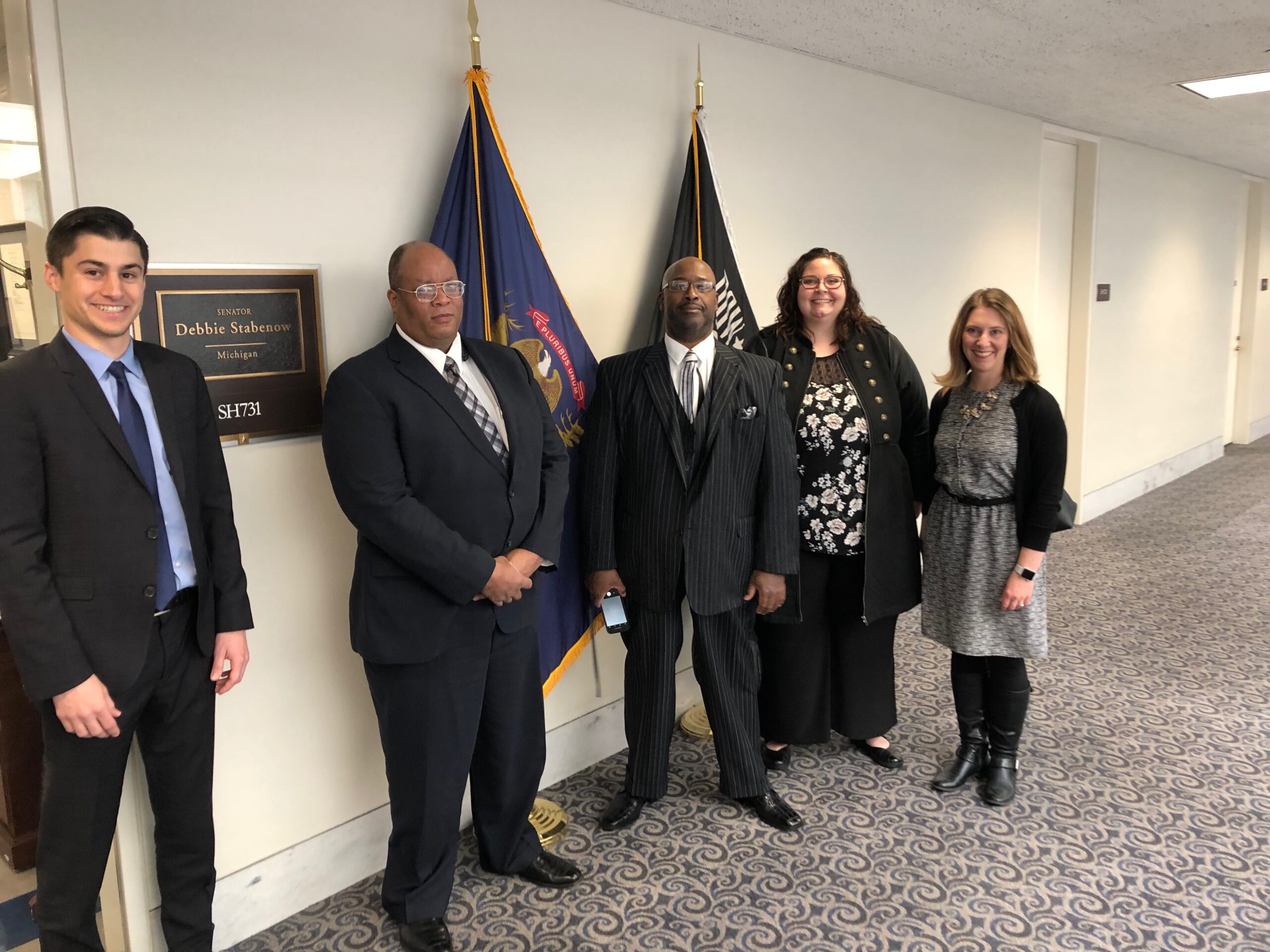 Author Jen Mullins and others posing with legislative staff.