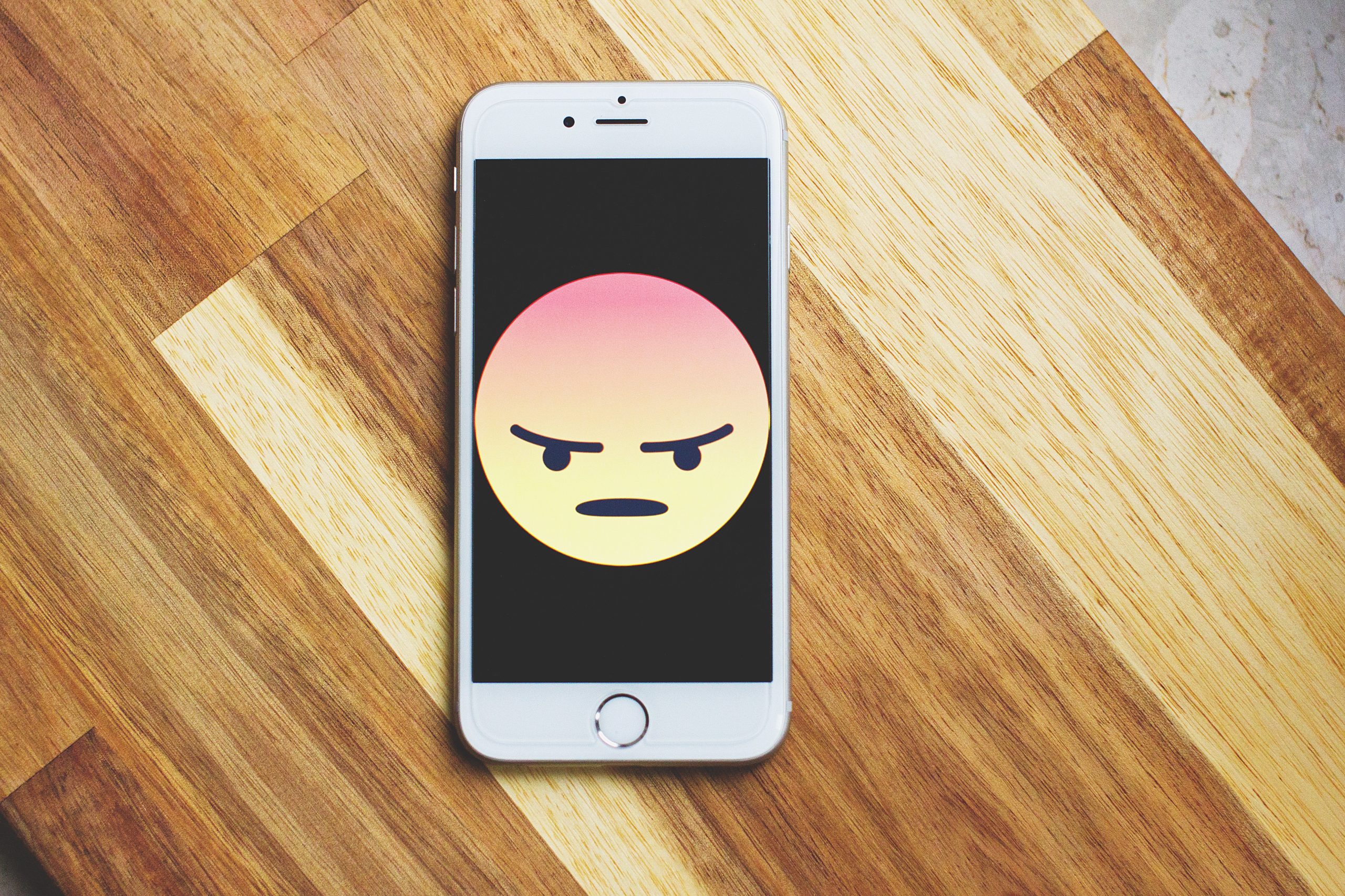 angry-phone-scaled Smart phone displaying the angry face emoji