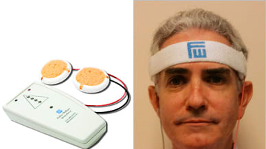 The device is shaped like an elongated deck of cards and has a pyramid on the front with four lights in the pyramid indicating the strength of the neurostimulation and two cords attached to two sponge electrodes.