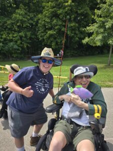 AT Fishing MATP staff member smiling and posing with MATP program participant using fishing AT